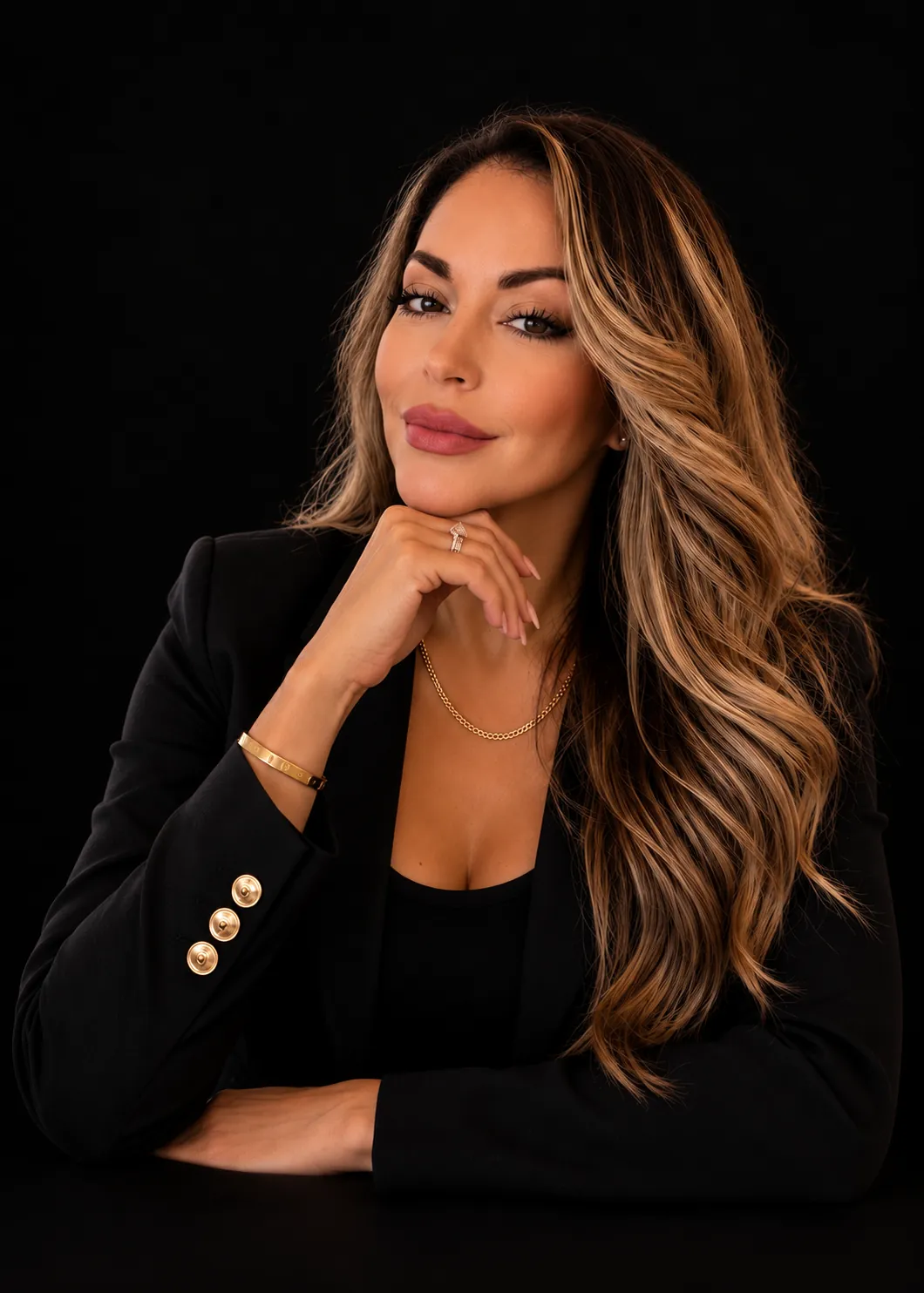 Vicki Valdovinos in a black blazer, photographed against a dark backdrop
